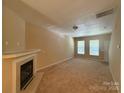 Inviting living room with a fireplace and neutral-toned carpet providing a cozy atmosphere for relaxation and entertainment at 3527 Creeping Flora Ln, Charlotte, NC 28216
