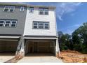 Spacious two car garage in modern townhome with white and grey siding at 408 Nathaniel Way # Brx0053, Charlotte, NC 28213