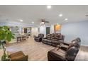 Living room featuring hardwood floors, a ceiling fan, views of the kitchen, and a comfortable seating arrangement at 430 Edgegreen Dr, Charlotte, NC 28217