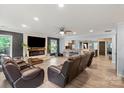 Spacious living room with a stone fireplace, hardwood floors, and plentiful natural light and open to the kitchen at 430 Edgegreen Dr, Charlotte, NC 28217