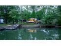 Picturesque waterfront home with a private dock and gazebo reflected in the calm water, surrounded by lush green trees at 4599 B & C Dr, Catawba, NC 28609