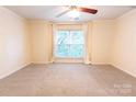 Bright, carpeted bedroom featuring a ceiling fan and a large window at 525 N Graham St, Charlotte, NC 28202