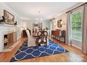 Elegant dining room with a fireplace, hardwood floors, and lots of natural light at 5624 Warewhip Ln, Charlotte, NC 28210