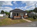 Charming home featuring front porch with wooden railing and fresh landscaping at 62 Fourth St, Cramerton, NC 28032