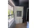 Old entryway with a partial view of the exterior through a window at 723 Pee Dee Ave, Albemarle, NC 28001