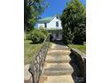 View of a two-story home with steps leading to a covered porch at 723 Pee Dee Ave, Albemarle, NC 28001