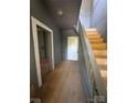 Hallway featuring carpeted stairs and aged walls at 723 Pee Dee Ave, Albemarle, NC 28001