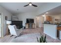 Comfortable living room featuring a fireplace, ceiling fan and wood laminate flooring at 744 Chipmeadow Ln, York, SC 29745
