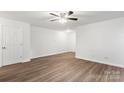 Bright bedroom featuring hard surface floors, ceiling fan, and neutral walls at 7616 Monarch Birch Ln, Charlotte, NC 28215