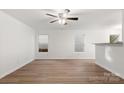 Open-concept living area featuring hard surface floors and abundant natural light from multiple windows at 7616 Monarch Birch Ln, Charlotte, NC 28215