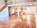 Expansive living area showcases hardwood floors, open layout, and a view of the kitchen at 7811 Babe Stillwell Farm Rd, Huntersville, NC 28078