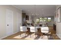 Open-concept dining area featuring seating for six, flowing seamlessly into the modern kitchen at 817 Garringer Pl, Charlotte, NC 28208