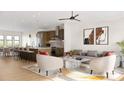 Open-concept living room and kitchen with hardwood floors, modern furnishings, and neutral color palette at 817 Garringer Pl, Charlotte, NC 28208