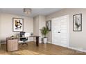 Neutral-toned office featuring modern desk, comfortable chair, minimalist decor, and hardwood flooring at 817 Garringer Pl, Charlotte, NC 28208