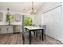 Eat-in kitchen dining area next to stainless steel dishwasher and backyard sliding glass door at 8809 Reedy Creek Rd, Charlotte, NC 28215