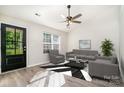 Bright living room with vaulted ceilings, fan, grey furnishings, and a black and white rug at 8809 Reedy Creek Rd, Charlotte, NC 28215