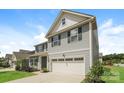 Side view of a charming two-story home with blue siding and a two-car garage at 9127 Colwick Hill Ln, Charlotte, NC 28215