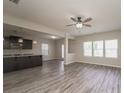 Open-concept living area with gray wood floors seamlessly connecting to a modern kitchen at 9127 Colwick Hill Ln, Charlotte, NC 28215