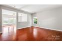 Spacious living room showcasing hardwood floors, neutral paint, and natural lighting at 9414 Seamill Rd, Charlotte, NC 28278