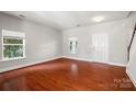 Bright living room with gleaming hardwood floors, neutral walls, and plenty of natural light at 9414 Seamill Rd, Charlotte, NC 28278