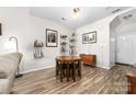 Cozy dining area with round wood table, adjacent to the living room and entrance at 1006 Phil Oneil Dr, Charlotte, NC 28215