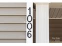 Close up of the house number '1006' attached to the exterior of the home at 1006 Phil Oneil Dr, Charlotte, NC 28215