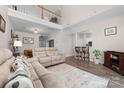 Open-concept living room featuring high ceilings and hardwood floors and view to loft area at 1006 Phil Oneil Dr, Charlotte, NC 28215