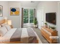 Comfortable bedroom with a large window providing ample natural light and a cozy atmosphere at 1043 Park West Dr, Charlotte, NC 28209