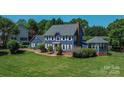 Charming two-story home with classic blue siding, white trim, and mature landscaping on a large lot at 106 Chatworth Ln, Mooresville, NC 28117