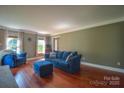 Inviting living room with hardwood floors, large windows, and comfortable blue seating at 106 Chatworth Ln, Mooresville, NC 28117