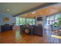 Bright living room featuring hardwood floors, vaulted ceilings, a fireplace, and large windows at 106 Chatworth Ln, Mooresville, NC 28117