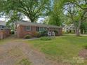 Charming single-story brick house with well-kept lawn and landscaping at 1100 Clawson Ct, Charlotte, NC 28209