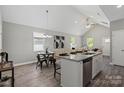 Open-concept living space with hardwood floors, vaulted ceilings, and a granite-topped kitchen island at 1101 Kenly St, Salisbury, NC 28144