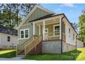 Charming home with a cozy front porch and light green siding at 1103 Kenly St, Salisbury, NC 28144