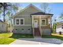 Charming home with a cozy front porch and light green siding at 1103 Kenly St, Salisbury, NC 28144