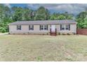 Welcoming single-story home features a simple facade and a neatly kept lawn, perfect for comfortable living at 119 Marietta Rd, Mooresville, NC 28117