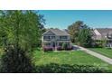 Beautiful two-story home boasting a manicured lawn, mature trees, and lovely curb appeal at 136 Wood Duck Loop, Mooresville, NC 28117