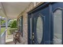 Close up of the beautiful navy blue front door with glass inserts and brick entryway at 136 Wood Duck Loop, Mooresville, NC 28117