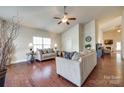 Spacious living room with hardwood floors, neutral walls, and comfortable sofas under a ceiling fan at 14113 Highland Meadow Rd, Charlotte, NC 28273