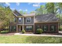 Two-story brick and siding home featuring a well-maintained lawn and walkway leading to the front door at 15324 Yarmouth Rd, Mint Hill, NC 28227