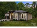 Attractive brick home with a modern garage, manicured lawn, and stylish front facade at 1534 Easy St, Belmont, NC 28012