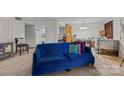 Cozy living room featuring a blue couch and views into the kitchen at 1832 J Julian Ln, Charlotte, NC 28208