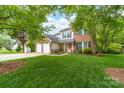 Charming two-story brick and siding home with a well-manicured lawn and a two-car garage at 1916 Pine Mountain Rd, Charlotte, NC 28214