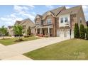 Beautiful two-story brick home with a well-manicured lawn and a three-car garage at 2041 Topaz Plz, Davidson, NC 28036