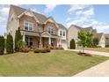 Beautiful brick home with a manicured lawn and vibrant landscaping, offering curb appeal and neighborhood charm at 2041 Topaz Plz, Davidson, NC 28036