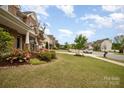 Inviting street view showcasing well-maintained lawns and landscaping, offering curb appeal and community charm at 2041 Topaz Plz, Davidson, NC 28036