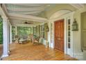 Relaxing front porch with wicker furniture, a ceiling fan, and a decorative wooden front door at 2126 Norton Rd, Charlotte, NC 28207