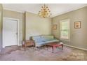 Cozy living room featuring classic furniture, a chandelier, and natural light from a window at 252 7Th Se St, Hickory, NC 28602