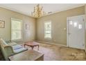 Vintage-style living room showcasing a chandelier, classic furniture, and two bright windows at 252 7Th Se St, Hickory, NC 28602