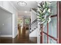 Elegant foyer showcasing hardwood floors, staircase with iron railings, and a view into adjacent living spaces at 2625 Rea Pond Ct, Charlotte, NC 28226
